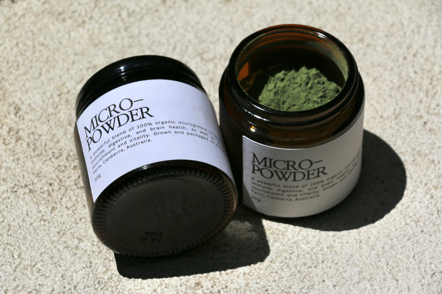 Jar of Organic Microgreens Powder with ingredients: red amaranth, broccoli, kale, kohlrabi.